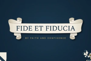 A heraldic ribbon scroll on navy reading Fide et Fiducia, with its translation By Faith and Confidence beneath